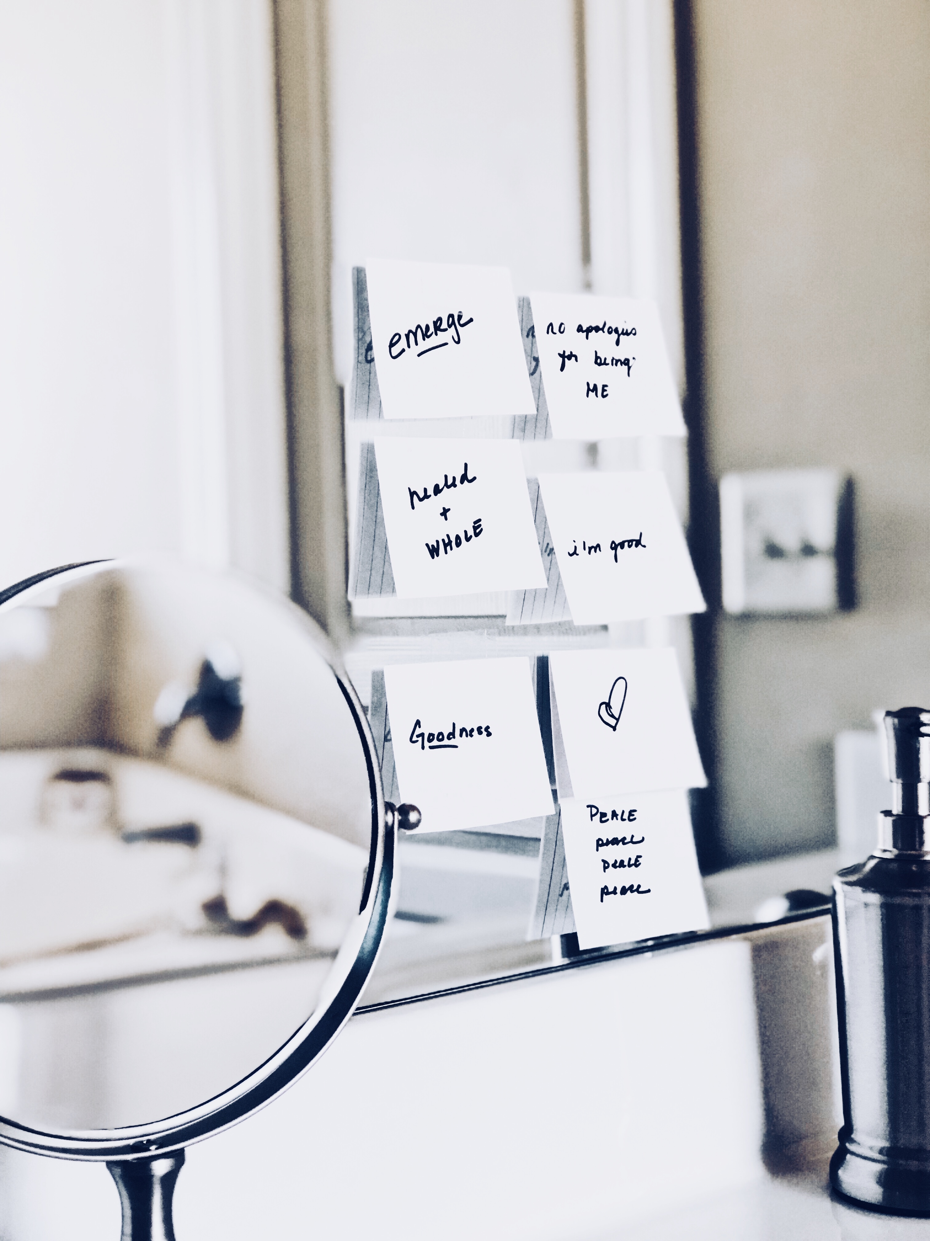 A mirror with sticky notes full of affirmations